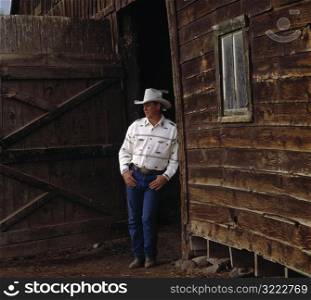 Cowboy Leaning on Barn