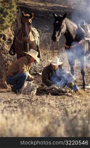 Cowboys Putting out Campfire