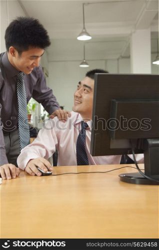 coworkers discussing the project over the computer screen