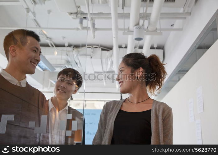 Coworkers walking out of the meeting room