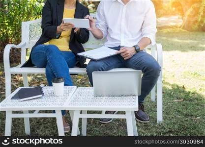 Coworking conference, Business team meeting present, investor executive colleagues discussing new plan financial graph data on outdoors office table with laptop and tablet, Finance, accounting. Coworking conference, Business team meeting present, investor ex