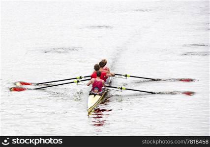 Coxed four rowing towards the camera, on a bleak day in open water