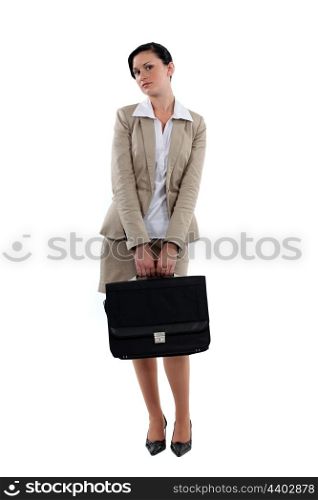 Coy businesswoman stood with briefcase