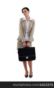 Coy businesswoman stood with briefcase