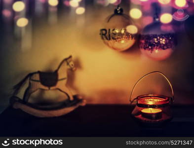 Cozy Christmas home with festive decoration, candle , rocking horse and bokeh lighting