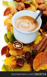 cozy cup of coffee and autumn leaves over white