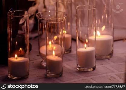 cozy decor with candles burning in glass flasks.. cozy decor with candles burning in glass flasks