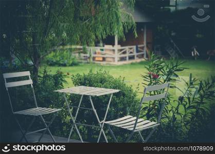 Cozy design chair and table in the garden; natural feeling