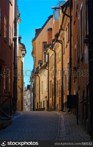 Cozy streets of the old town in Stockholm with yellow houses. Sweden
