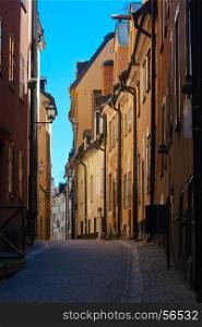 Cozy streets of the old town in Stockholm with yellow houses. Sweden