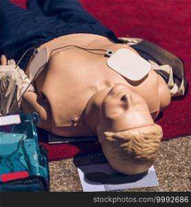 CPR doll. First Aid Training. Defibrillator CPR Practice