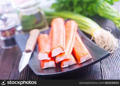 crab sticks on plate and on a table