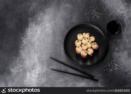 Crab sticks stuffed with rice, egg and green onions on a dark gray background. Crab sticks stuffed with rice, egg and green onions