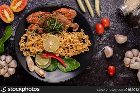 Crab Tom Yum Mama with Lemon, Chili, Tomato, Garlic, Lemongrass, Kaffir Lime Leaves on the plate