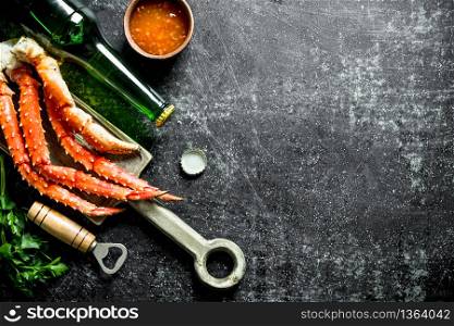 Crab with sauce, beer and herbs. On dark rustic background. Crab with sauce, beer and herbs.