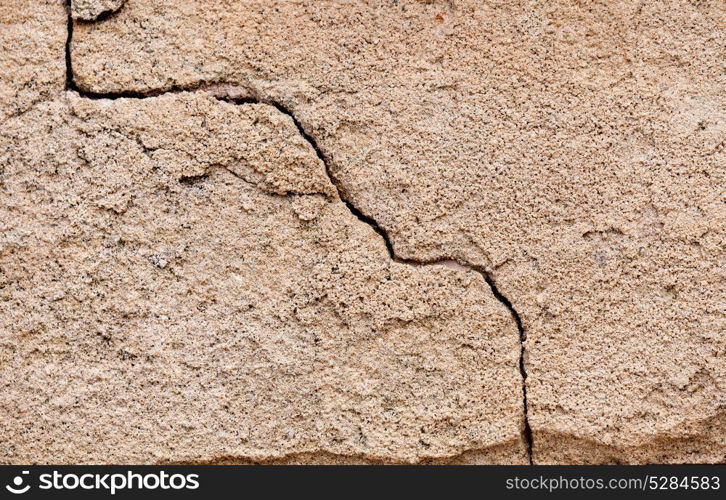 Crack in a wall on a cement surface