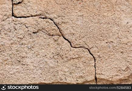 Crack in a wall on a cement surface