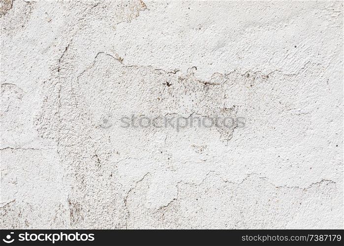 Crack in a white wall with cement brick surface