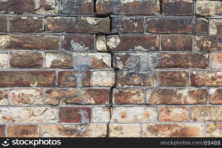 crack in the wall of red bricks, close up