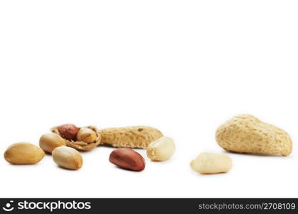 cracked and closed peanuts. some cracked and closed peanuts on white background