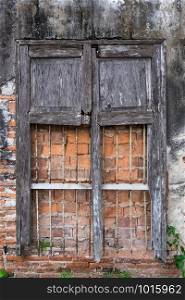 Cracked and decayed brick stucco wall texture background with old vintage window frame weathered long time ago.