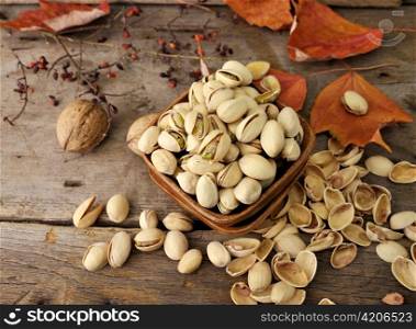 Cracked and Dried Pistachio Nuts In A Wooden Bowl