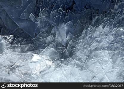 Cracked blue ice on frozen water