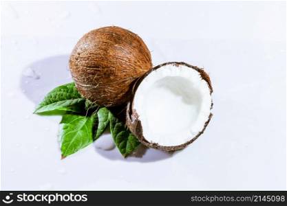cracked coconut with big splash, isolated on white. cracked coconut