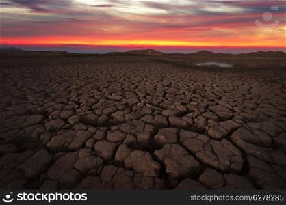 Cracked soil landscape after sunset