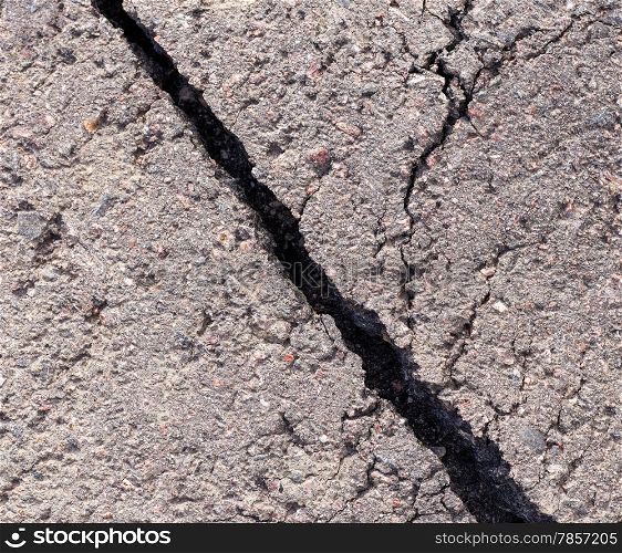 Cracked tarmac, deep wide hole and unrepaired