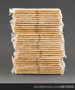 Crackers in plastic, isolated on a grey background