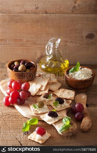 crackers with soft cheese olives grapes. healthy appetizer
