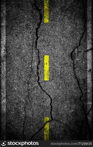 Cracks on asphalt the yellow line dividing lanes