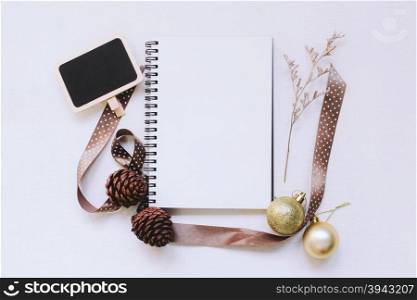 Craft and notebook mock up with christmas ornaments on white wood background