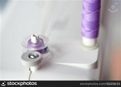 craft and tailoring concept - thread spools on sewing machine. thread spools on sewing machine
