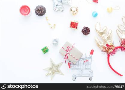 Craft gift box in shopping cart and Christmas gift boxes and decorations on white background
