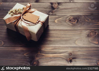 Craft gift box on table wooden background with copy space