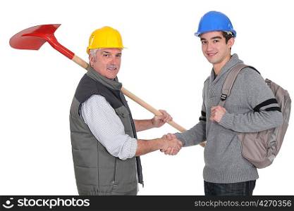 craftsman and apprentice shaking hands