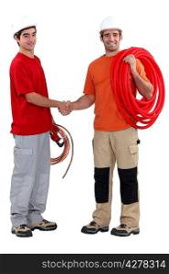 craftsman and apprentice shaking hands