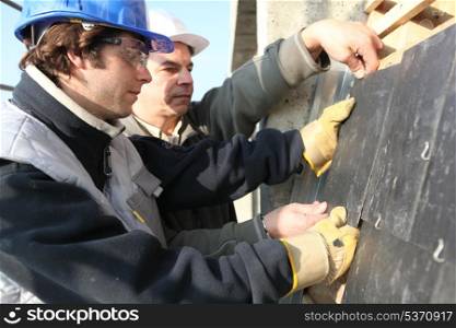 craftsman and apprentice working together