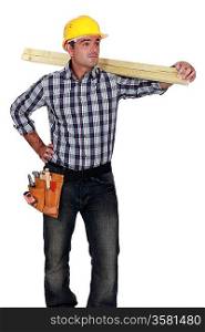craftsman carrying a wooden board