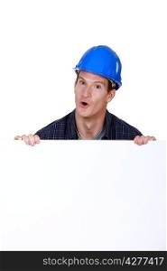 craftsman holding a blank poster