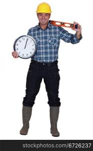 craftsman holding a clock and a level