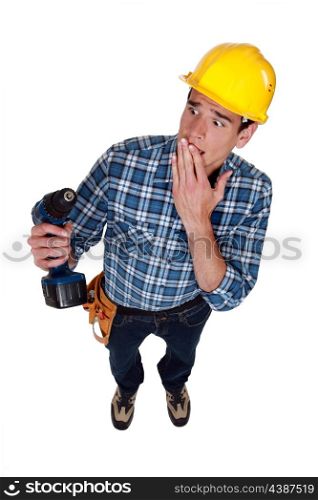 craftsman holding a drill and looking upset