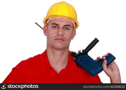 craftsman holding a drill on his shoulder