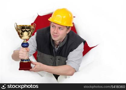 craftsman holding a golden cup