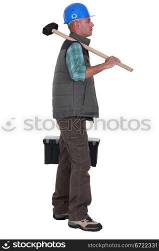 craftsman holding a hammer and a toolbox