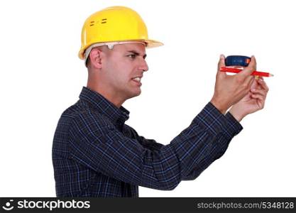 craftsman holding a meter