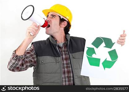 craftsman holding a recycling label and shouting through a megaphone