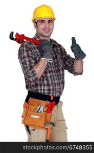 craftsman holding a spanner and making a thumbs up sign